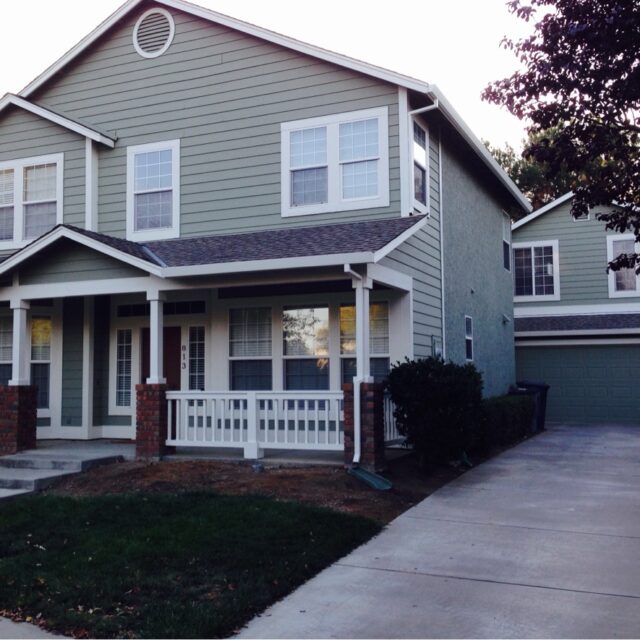 Exterior house painting in Sacramento, CA by Baldwin Custom Painting — gray craftsman bungalow with white trim and front porch
