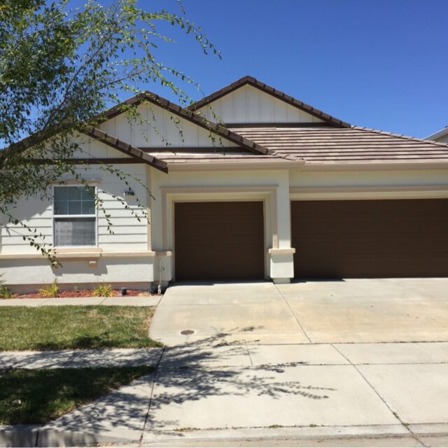 Exterior house painting in Sacramento, CA by Baldwin Custom Painting — gray two-story home with garage