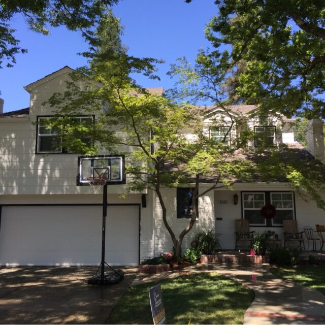 Exterior house painting in Sacramento, CA by Baldwin Custom Painting — beige two-story home with brown roof and garage