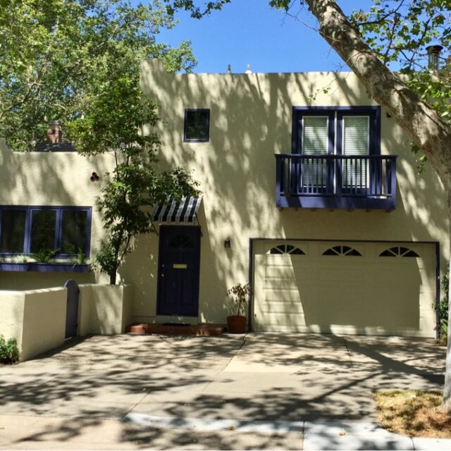 Exterior house painting in Sacramento, CA by Baldwin Custom Painting — white home with red front door and porch