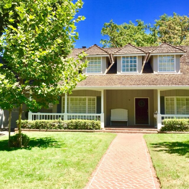 Exterior house painting in Sacramento, CA by Baldwin Custom Painting — white cottage with porch swing