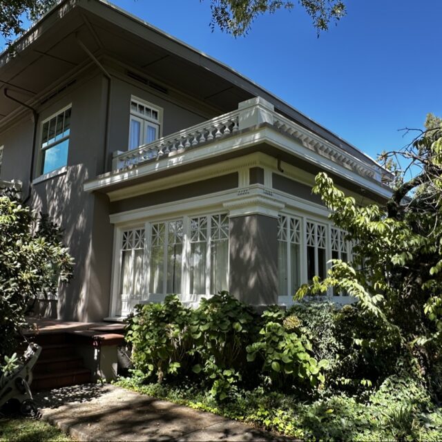 Exterior house painting in Sacramento, CA by Baldwin Custom Painting — gray two-story home with white trim and garage