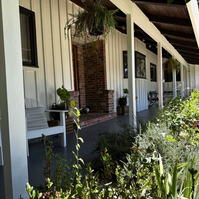 Exterior house painting in Sacramento, CA by Baldwin Custom Painting — brown ranch home with stone accents and white trim