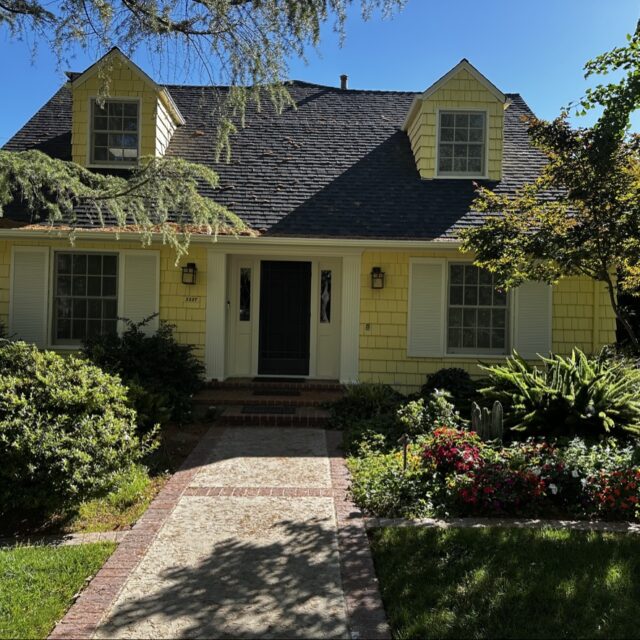 Exterior house painting in Sacramento, CA by Baldwin Custom Painting — beige two-story home with covered entry and garage