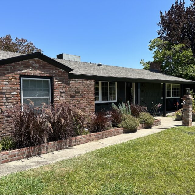 Exterior house painting in Sacramento, CA by Baldwin Custom Painting — brown ranch home with white trim and garage