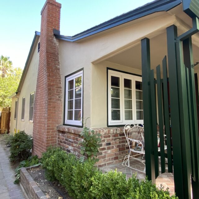 Exterior house painting in Sacramento, CA by Baldwin Custom Painting — brick chimney with beige siding and green fence