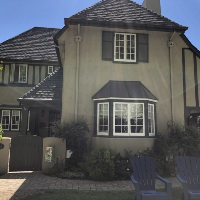 Exterior house painting in Sacramento, CA by Baldwin Custom Painting — two-story beige stucco home with dark trim