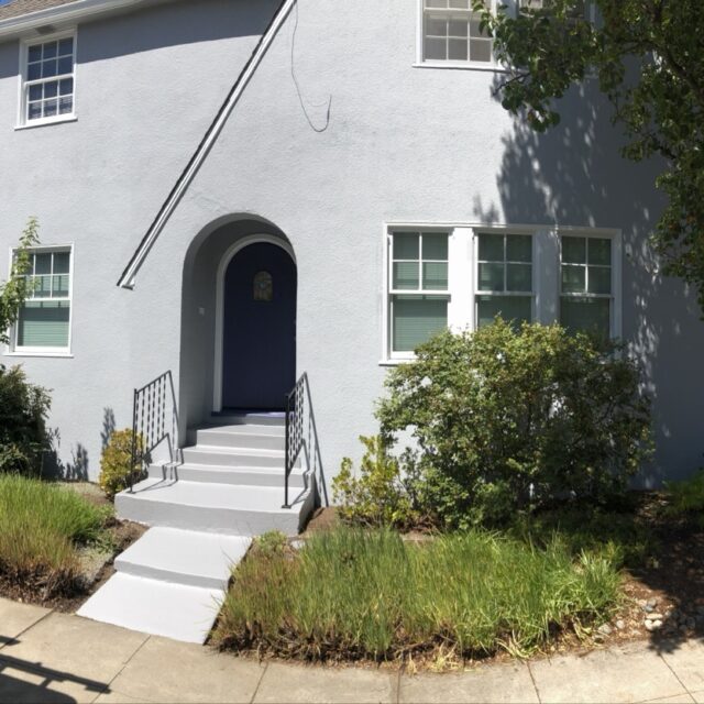 Exterior house painting in Sacramento, CA by Baldwin Custom Painting — white stucco home with arched doorway and tile accents