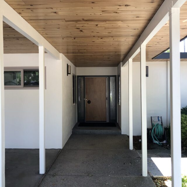 Exterior house painting in Sacramento, CA by Baldwin Custom Painting — covered front porch with wood ceiling and white columns