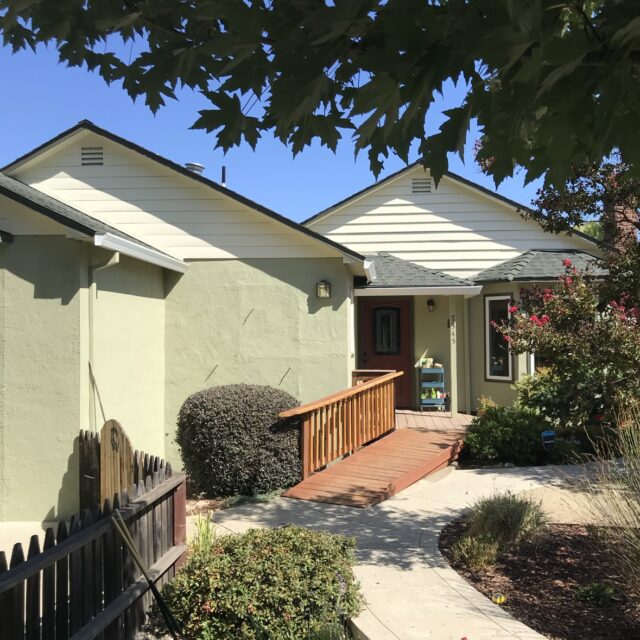 Exterior house painting in Sacramento, CA by Baldwin Custom Painting — beige two-story home with arched windows and garage