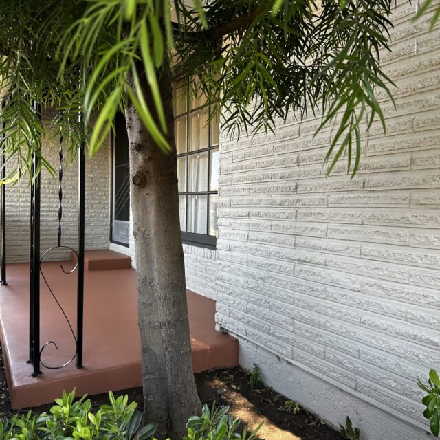 Exterior house painting in Sacramento, CA by Baldwin Custom Painting — white horizontal siding detail with red accent