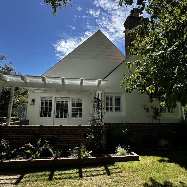 Exterior house painting in Sacramento, CA by Baldwin Custom Painting — white single-story cottage with gable roof