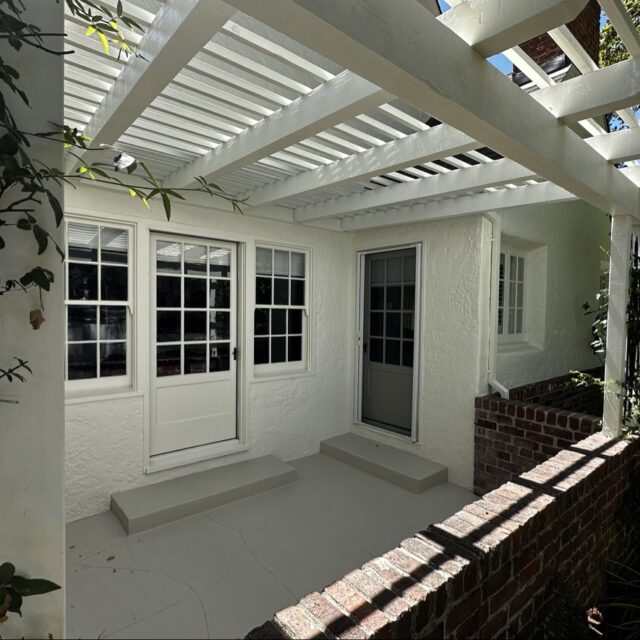 Exterior house painting in Sacramento, CA by Baldwin Custom Painting — sunroom with white framing and glass windows