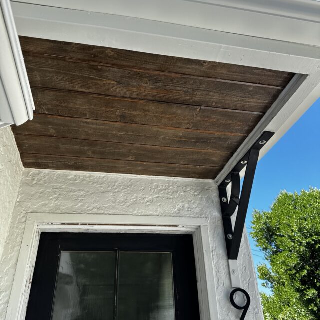 Exterior house painting in Sacramento, CA by Baldwin Custom Painting — stained wood porch ceiling close-up