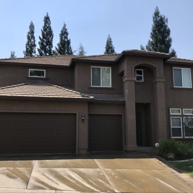 Exterior house painting in Sacramento, CA by Baldwin Custom Painting — two-story home with brown siding and balcony