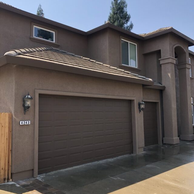 Exterior house painting in Sacramento, CA by Baldwin Custom Painting — two-story home with tan stucco and garage