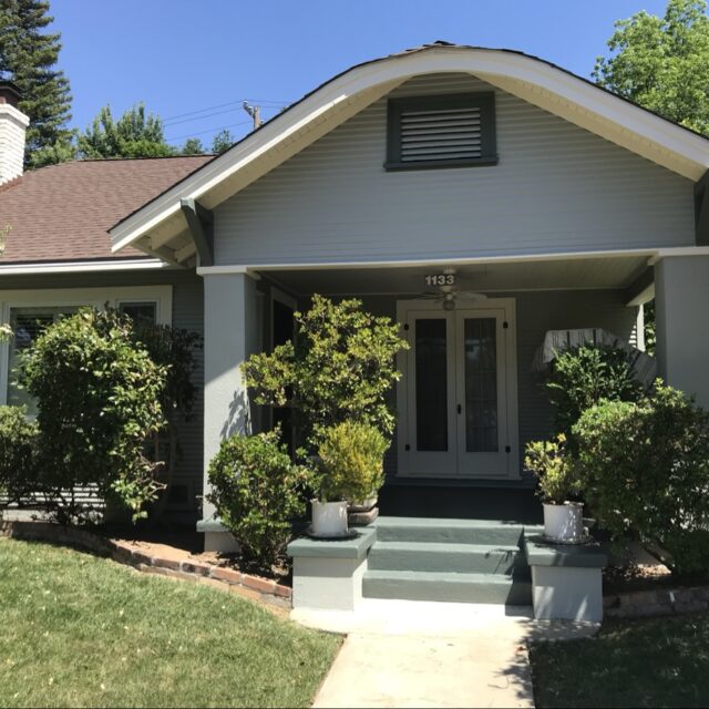 Exterior house painting in Sacramento, CA by Baldwin Custom Painting — light gray craftsman bungalow with columned porch