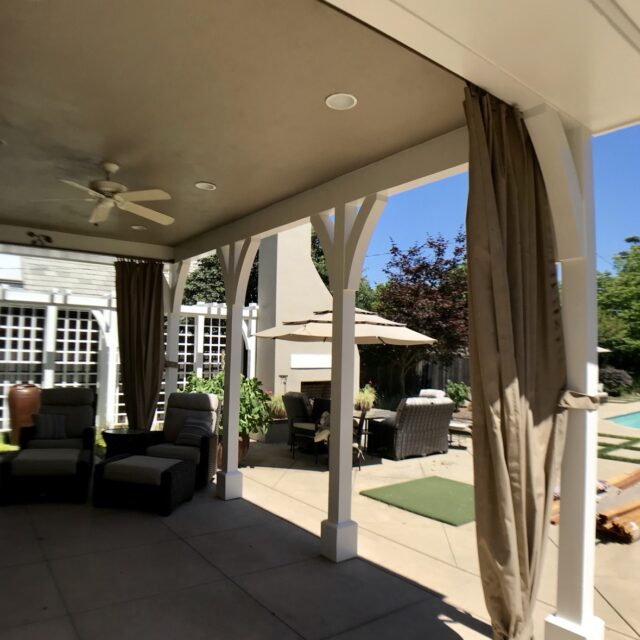 Exterior house painting in Sacramento, CA by Baldwin Custom Painting — covered patio ceiling painted in warm taupe with white beams, ceiling fan, and recessed lighting