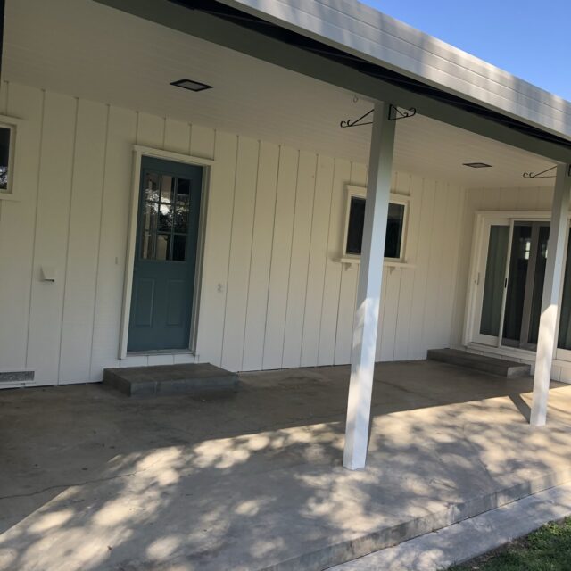Exterior house painting in Sacramento, CA by Baldwin Custom Painting — close-up of freshly painted white soffit and fascia over a covered patio