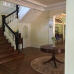 Upstairs landing with white balusters and dark handrail