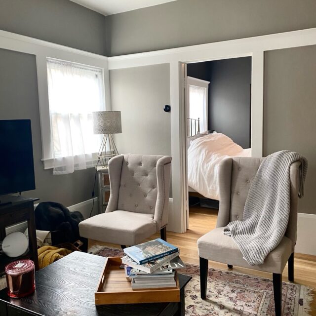 Interior house painting in Sacramento, CA by Baldwin Custom Painting — bedroom with gray walls, white trim and bright windows