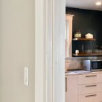 Dark blue-gray walls with white window and door trim