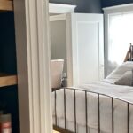 Doorway with white trim and dark green accent wall