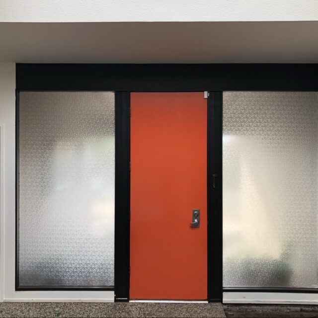 Front door refinishing in Sacramento, CA by Baldwin Custom Painting — mid-century modern entry with bold orange door